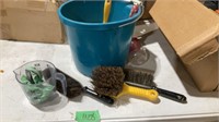 Assorted brushes and wire in bucket