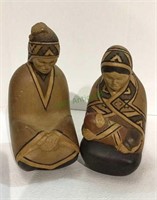 Carved wooden figures of man and woman with