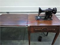 Singer sewing machine in cabinet