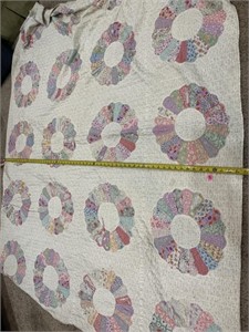 Vintage hand stitched quilt has some wear