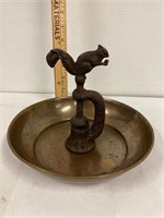 Cast iron squirrel nut cracker in a brass pan
