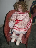 Doll with wicker chair