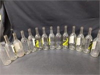 14 clear wine bottles