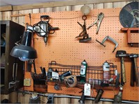 Tools on wall, oil cans, valve compresser, etc.