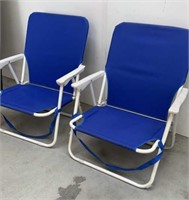 Two folding beach chairs