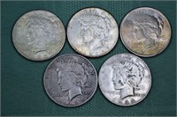 Five US Peace silver dollars: 1924, (3) 1925, 1935