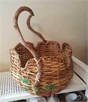 Hand woven basket with very curved handle