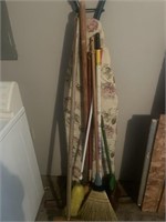 Metal ironing board, and brooms