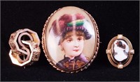 A Victorian pin with handpainted woman in