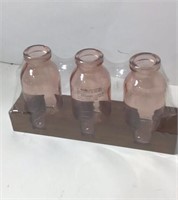3 Small Pink Glass Bottles In Wood Base. U15A
