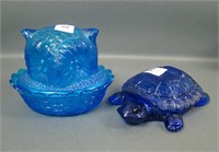 Two Blue Glass Covered Items