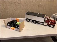 Peterbilt with broken box and a old truck
