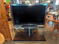 Sony Bravia Television with remote on stand