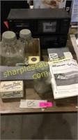 Stereo, jars, mower blades, advertising boxes