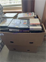 2 BOXES--DVDS, VHS TAPES, IN LIVING ROOM