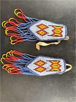 An intricately beaded pair of epaulets in Native A