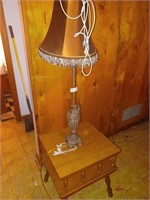 square wooden table and tall lamp