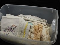 Two containers of linens: doilies, embroidered
