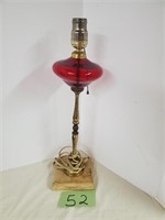 Red glass lamp on a wood base
