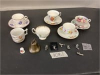 4 cups, saucer, and trinkets
