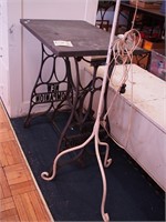 A sewing machine stand with slate top