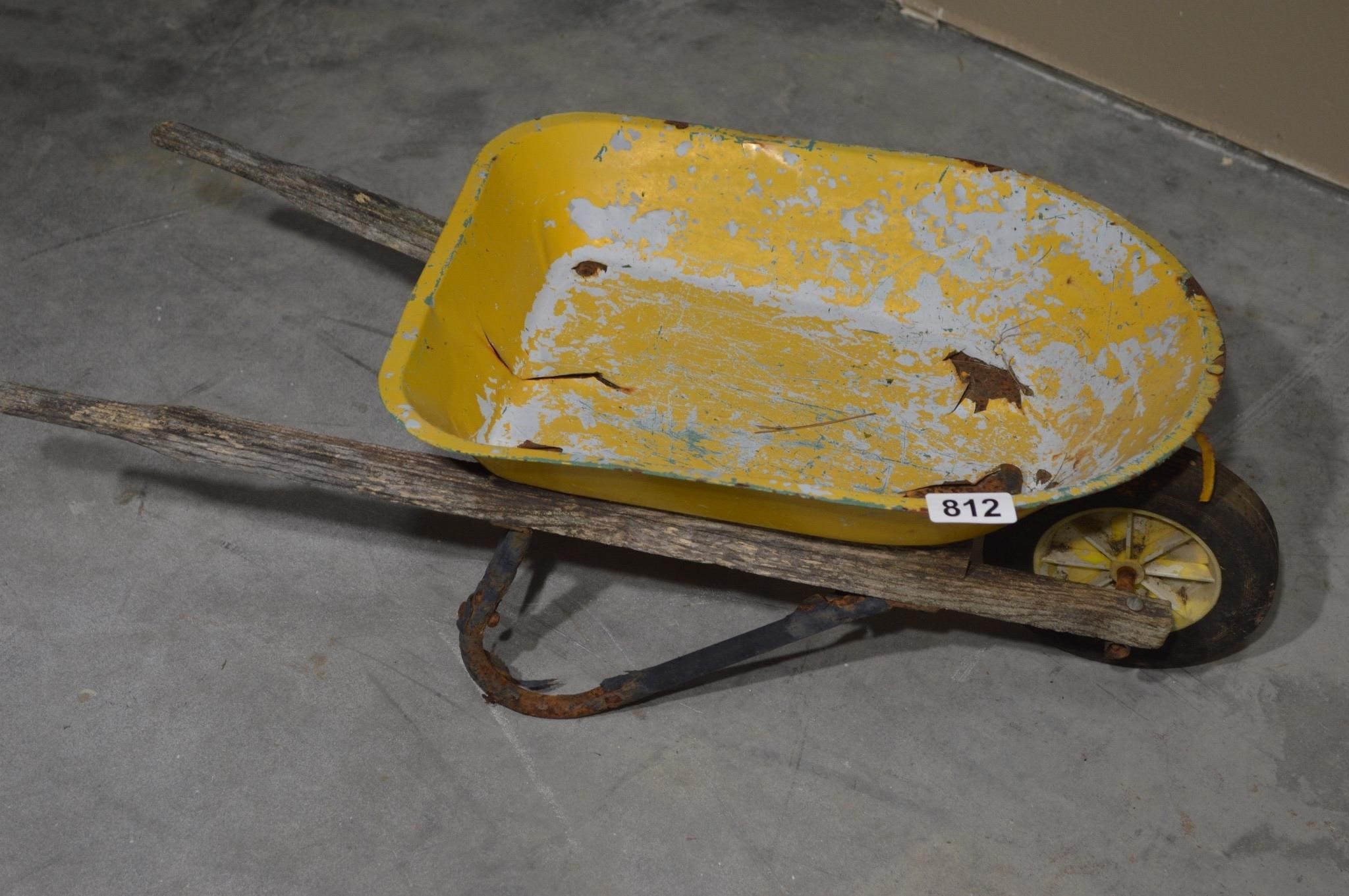 Child's sized yellow wheelbarrow - weathered