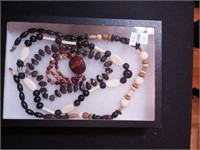Two containers of natural beaded jewelry including
