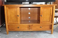 Wooden entertainment center (extra pegs in bottom