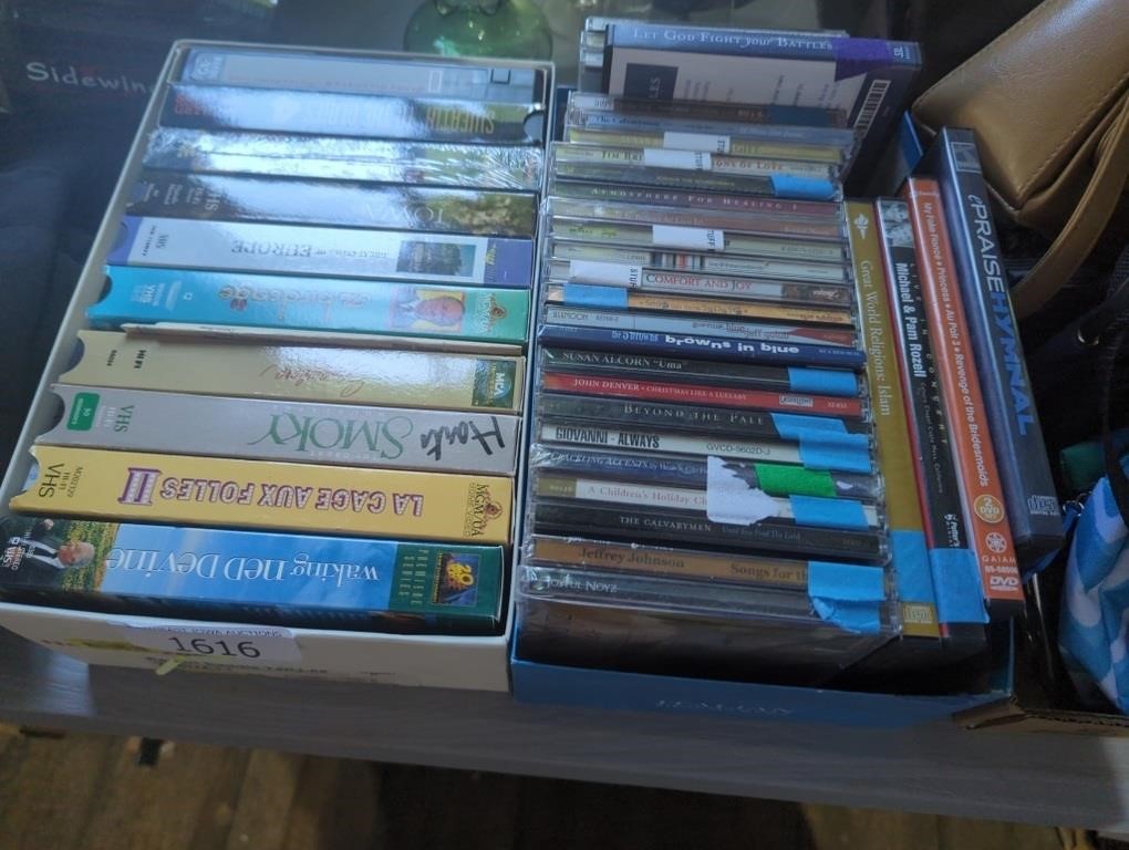 Box of VHS tapes and box of CDs