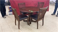 Cute round drop leaf table with four chairs,