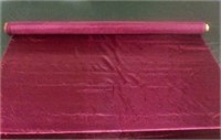 Roll of burgundy satin fabric