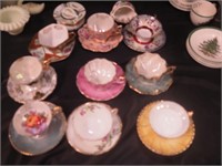 Eight highly decorated cups and saucers, some