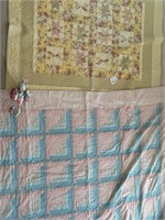 Two floral quilts and quilted cat