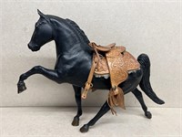 Black beauty horse with leather saddle