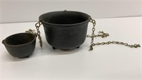 Two small cast iron cauldrons , one hangs, one