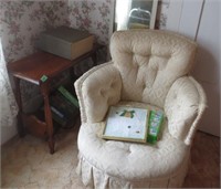 Upholsted chair, stand, books