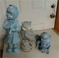Girl, concrete owl and cherub lawn statues