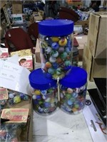 3 plastic jars of marbles.