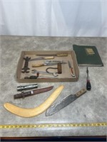 Assortment of knives, boomerang, match cover