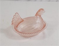 Pink Depression glass covered chicken dish