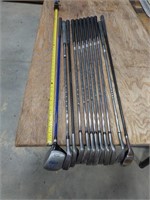 Miss-matched golf club set with bag and stand.