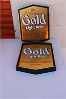 Two Olympia Gold Lite Beer signs