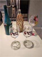 Delicately decorated wine bottle, wine glasses & m