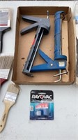 Assortment of different items, calk guns, paint