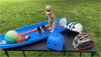 Toys including helmets, balls, sled , dinosaur