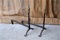 Old forged andirons with brass finial
