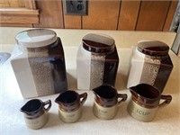 Canister set and 4 pottery measuring cups.