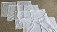 C2) 4 new, unused white pillow cases measuring 21”