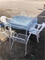 GLASSTOP TABLE AND 7 OUTSIDE CHAIRS
