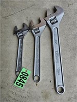 Three large adjustable wrenches